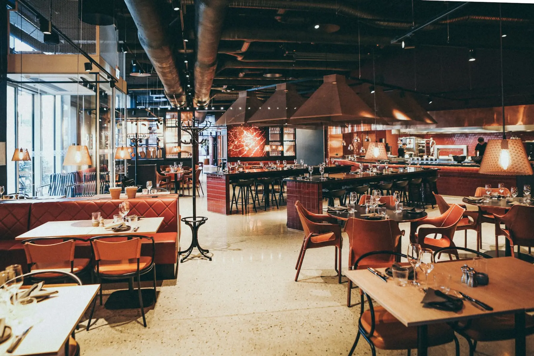 Restaurant dining room with leather booths and wooden tables
