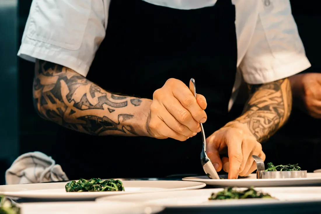 Chef plating a tasting menu course