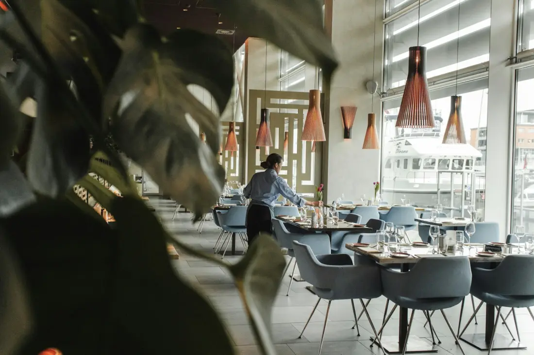 Front-of-house team member in a bright restaurant