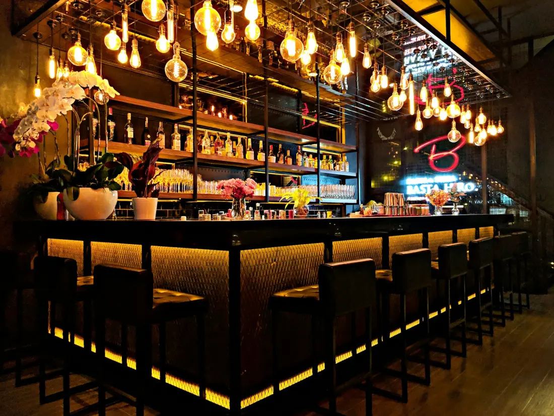 Pub bar lit with hanging filament bulbs