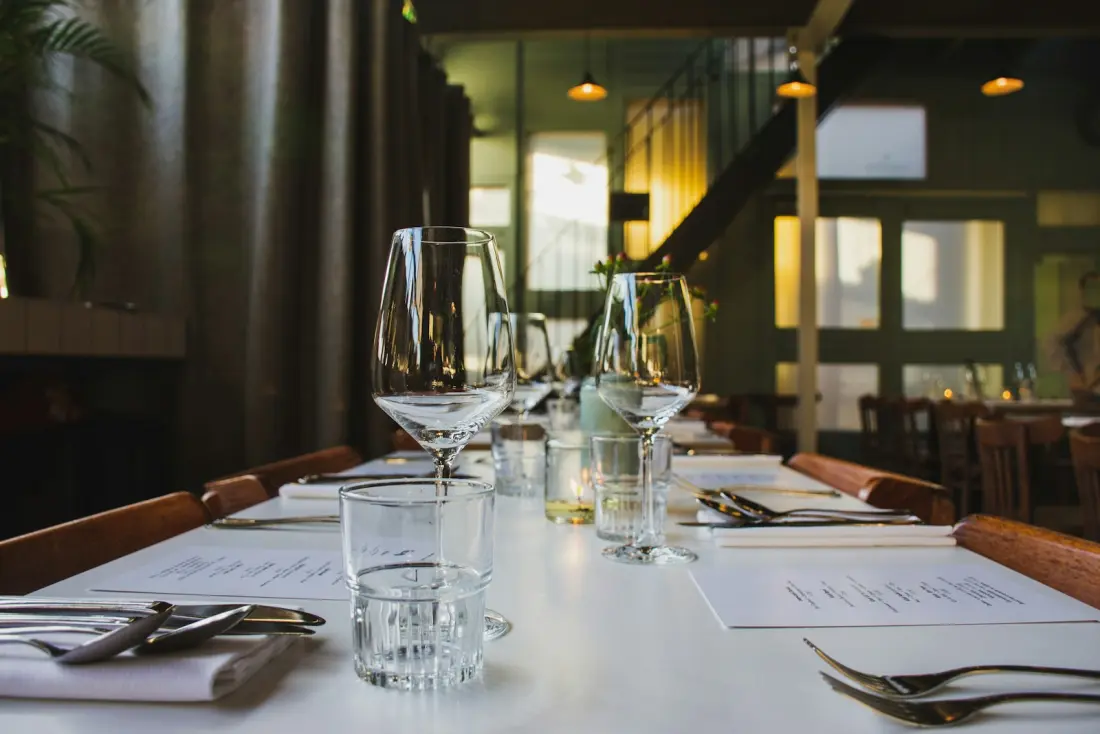 Restaurant table laid with wine glasses before service